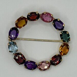 18k gold VTG brooch with multi color precious gems